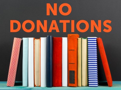 Stack of books with donations sign