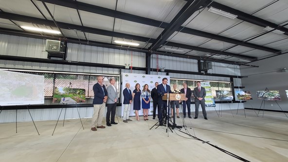 Governor DeSantis speaking at Bonnet Springs press conference with City Commission and others in background