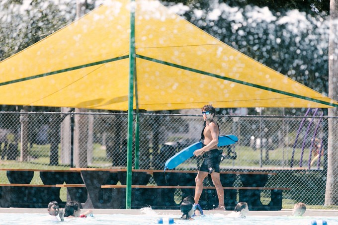 Lifeguard walking on the pool deck at Simpson Pool