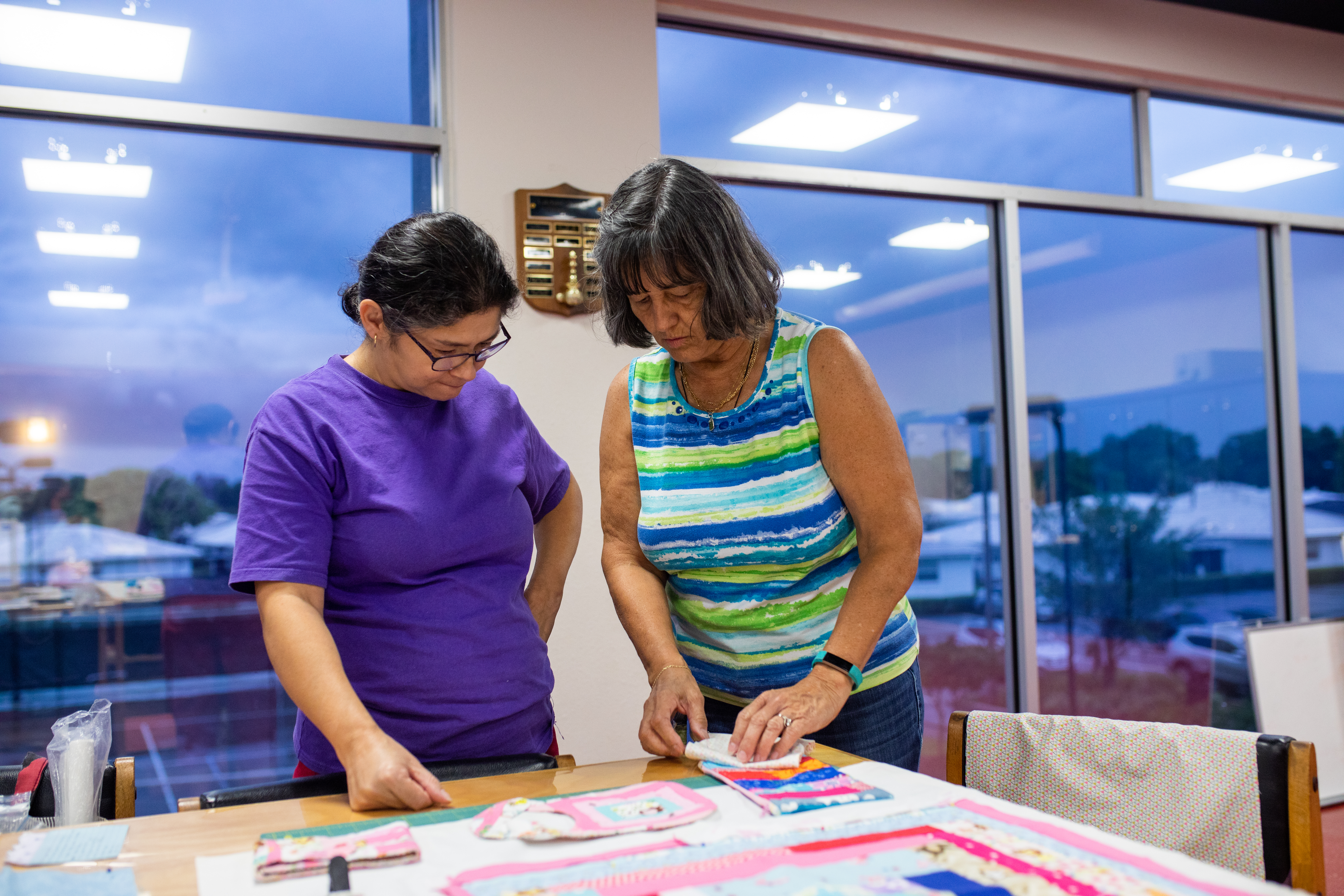 Two women working on a quilt