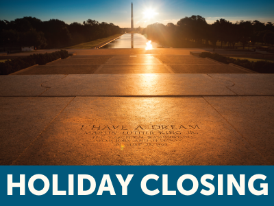 Sunrise view from Martin Luther King Jr. Memorial in Washington, D.C. facing "I Have a Dream" quote etched in marble and view of reflecting pool and Washington Monument with text Holiday Closing