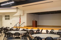 Lake Mirror Auditorium with view of the stage - set with 10-foot diameter round tables.