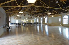 Interior view of the main room facing towards the Kitchen with the stage to the right.