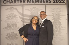 Two people posing in front of Charter Members 2022 sign in Lakeland History and Culture Center exhibit room