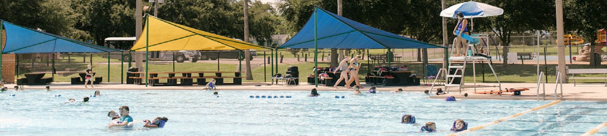 Photo of Simpson Park Pool with people spread out in the pool and a lifeguard in the background.