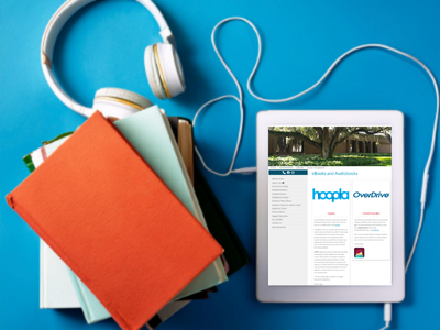 Stack of books and pair of headphones beside an ereader tablet showing library website on blue background; link to eBooks and Audiobooks page