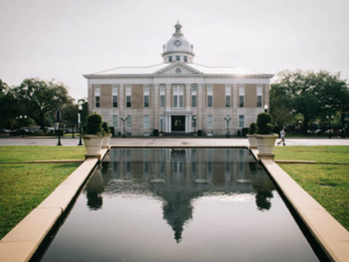 Exterior view of the old Polk County Courthouse in Bartow, Florida with reflecting pool