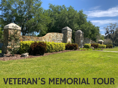 Stone wall entrance gate with grassy lawn and tall oak trees in the background at Oak Hill Burial Park with text Veteran's Memorial Tour; link to Lakeland Public Library "Veteran's Memorial Tour at Oak Hill Burial Park"; story map