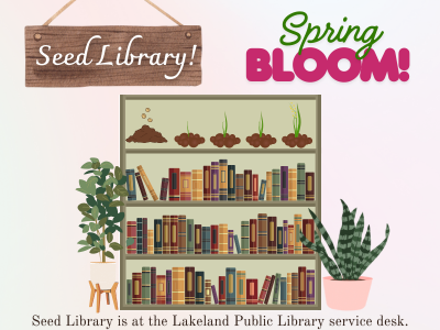 Bookcase with three shelves of books and one shelf of growing seeds surrounded by two potted plants and banner above "Seed Library! Spring Bloom" and text below Seed Library is at the Lakeland Public Library service desk