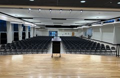 View of the room from the stage. Room set with chairs facing the stage.