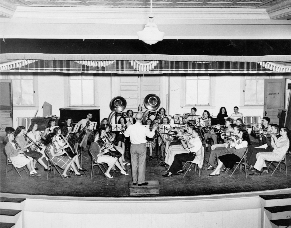 Lakeland High School Music and Drama Department director Harry Mayhall conducts the Lakeland High School orchestra in a rehearsal for an upcoming performance, circa 1940s; link to "Harry S. Mayhall" contentDM collection