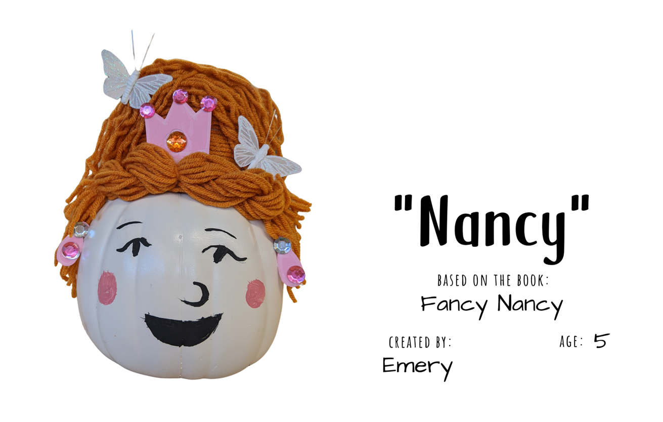 Craft pumpkin painted to look like a woman with red hair and pink crown with text "Nancy; Based on the book Fancy Nancy; Created by: Emery, Age 5"
