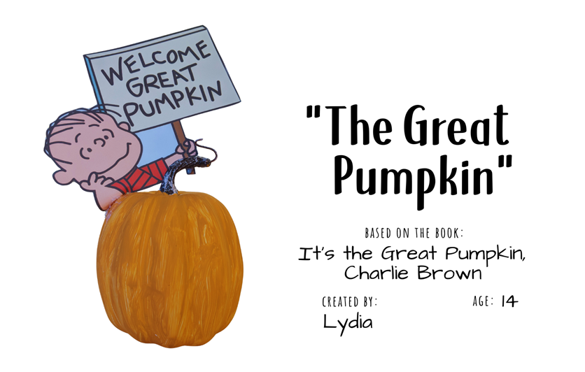Craft pumpkin painted orange with cutout of Linus holding a sign "Welcome Great Pumpkin" with text "The Great Pumpkin; Based on the book It's the Great Pumpkin, Charlie Brown; Created by: Lydia, Age 14"