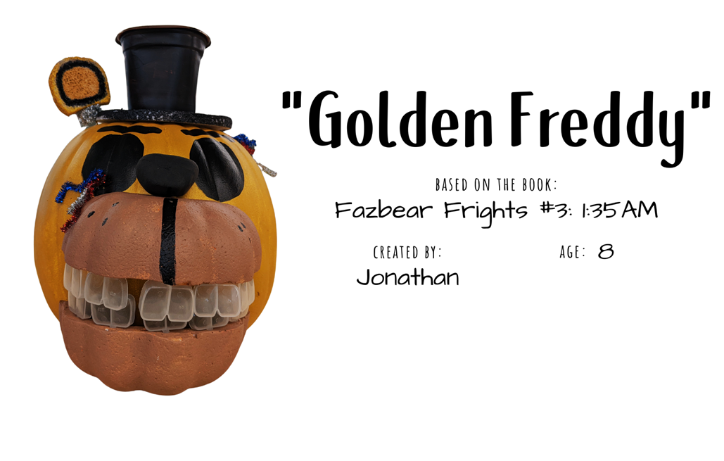 Craft pumpkin decorated to look like a smiling golden bear wearing a top hat with text "Golden Freddy; Based on the book Fazbear Frights #3: 1:35 AM; Created by: Jonathan, Age 8"