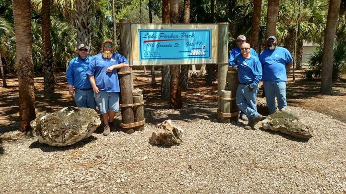 A picture of employees around Lake Parker Park signage