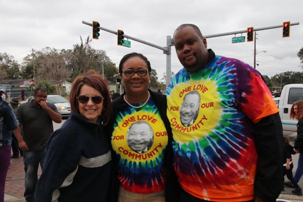 Photo of three people. The two on the right are wearing tie dyed shirts